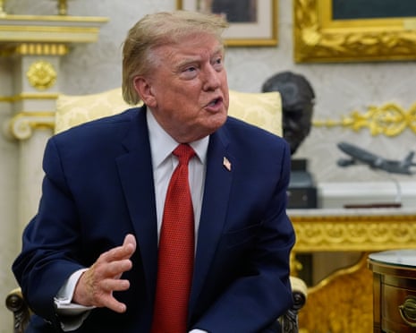 Donald Trump speaks to reporters in the Oval Office.