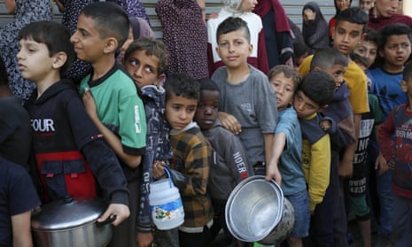 Children with pots and pans queue up for food