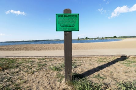 A water quality notice sign hangs near the beach at Big Creek state park, in Polk City, Iowa.