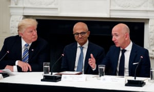 Microsoft CEO Satya Nadella sits between Donald Trump and Jeff Bezos at a White House meeting last year.