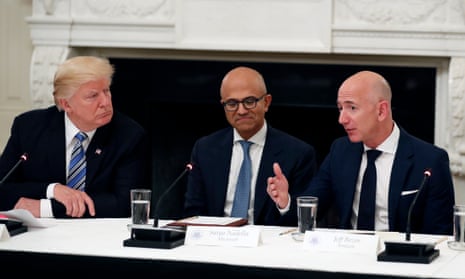 Microsoft CEO Satya Nadella sits between Donald Trump and Jeff Bezos at a White House meeting last year.
