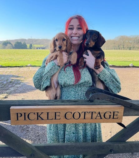 Stacey Solomon and her dogs at the gate to Pickle Cottage.