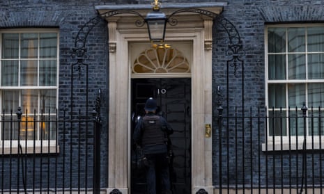 A police officer at the door of Downing Street.