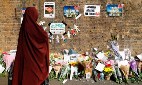 A woman stops to read tributes for the victims of the van attack
