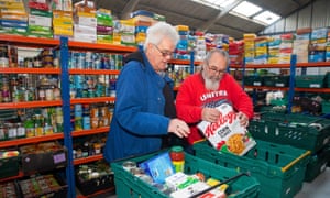 Don Gardner (left) and volunteer Ray Richards packing food at the Transformation CPR foodbank.