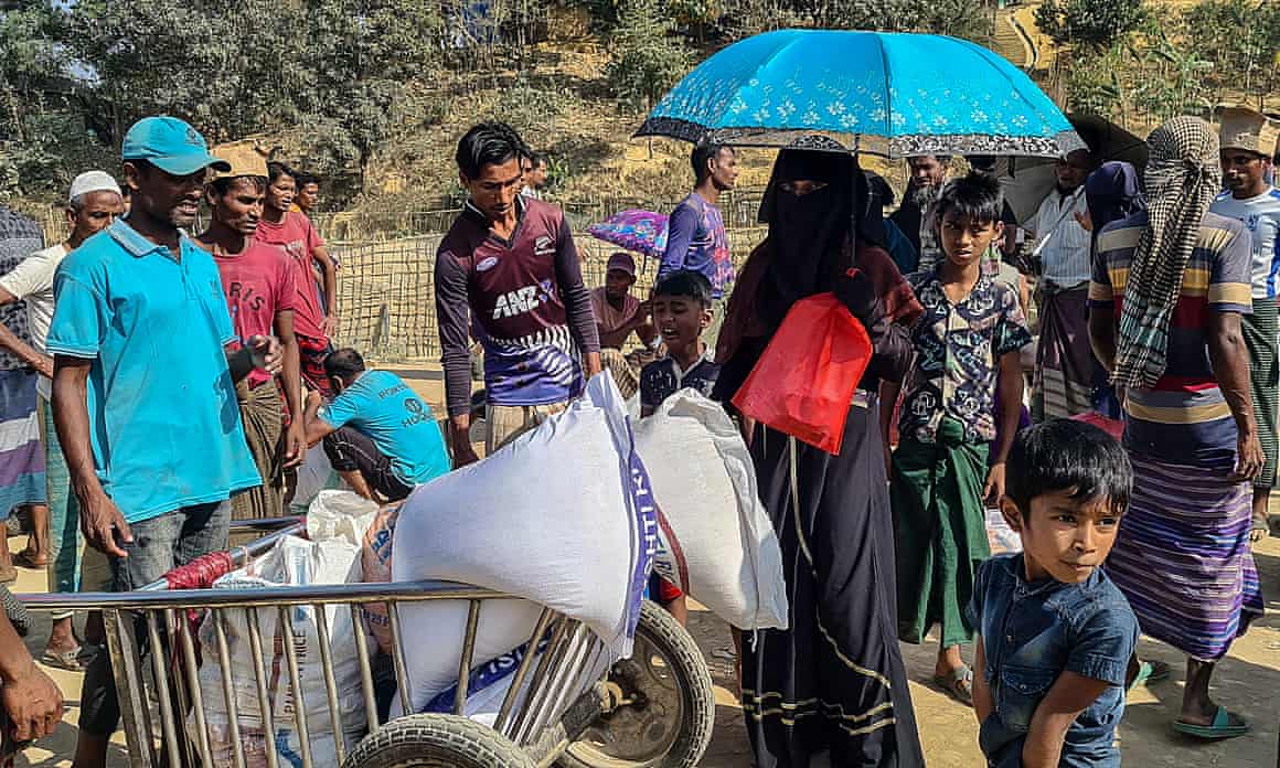 Rohingya refugees gather to collect relief materials from a distribution point in the Kutupalong camp in Cox’s Bazar, Bangladesh.