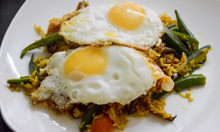 Vegetable biryani rice topped with fried egg