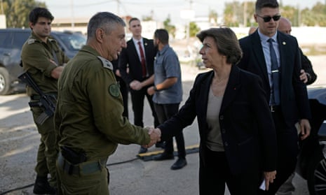 Catherine Colonna is greeted by Israeli Col. Olivier Rafowicz as she arrives at the Shura military base in central Israel.