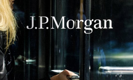 A woman exits JPMorgan Chase headquarters on Park Avenue in New York,