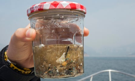 A glass jar containing a sample of microplastics collected in a fine mesh trawl of sea surface microplastics in Hong Kong.