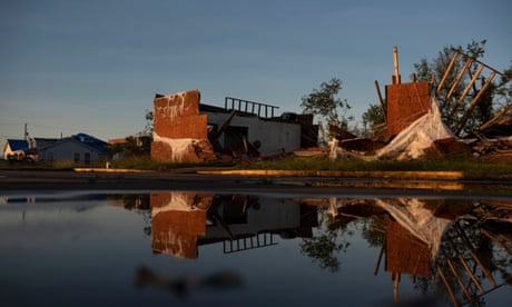 A destroyed building is reflected in standing water after Hurricane Delta landed in Lake Charles, Louisiana on 10 October.