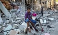 A wounded boy sits among the rubble of a house hit by an Israeli strike in Rafah.