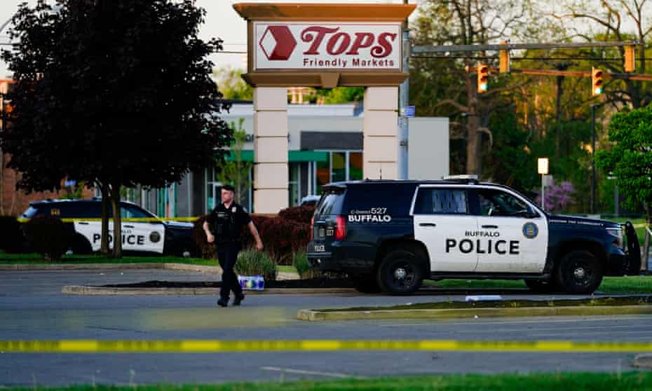 A police officer walks near the scene of a shooting at a supermarket, in Buffalo, New York, on Sunday.