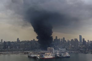 Black smoke rises from a fire at warehouses at the seaport of Beirut.
