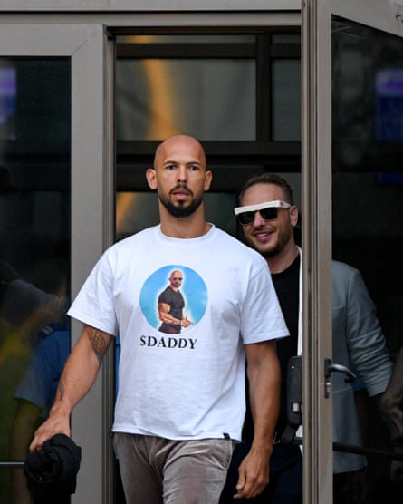 Andrew Tate, wearing a T-shirt with himself on the front, leaving court in Bucharest.