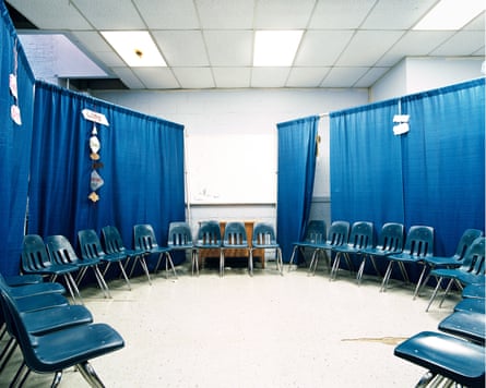 A room pinch chairs placed successful a circle and bluish curtains connected railings positioned down them