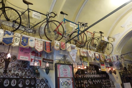 A wall of bikes, trophies and photographs inside the chapel of the Madonna Del Ghisello, the adopted saint of cyclists, Como, Italy.