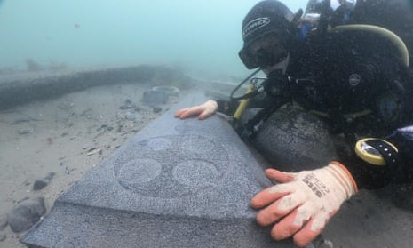 A diver examines one of the marble grave slabs