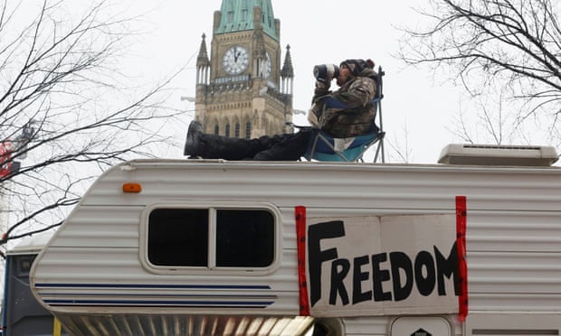 A protester sits on top of a campervan outside Parliament Hill in Ottawa.