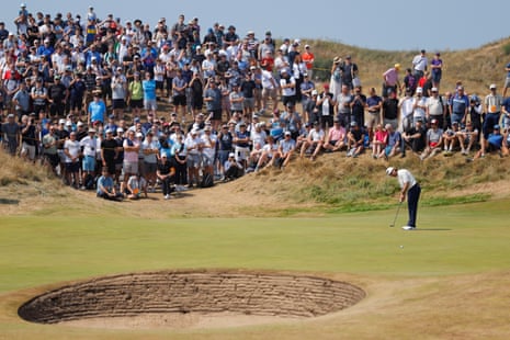 Tommy Fleetwood makes hi putt on the 1st green.