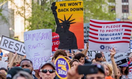 A placard reading ‘Immigrant rights = workers’ rights’ is seen as immigrants, workers and activists march in New York City on 1 May 2017.