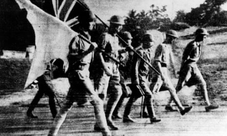 British forces, carrying union and white flags, surrender to the Japanese in Singapore in 1942.