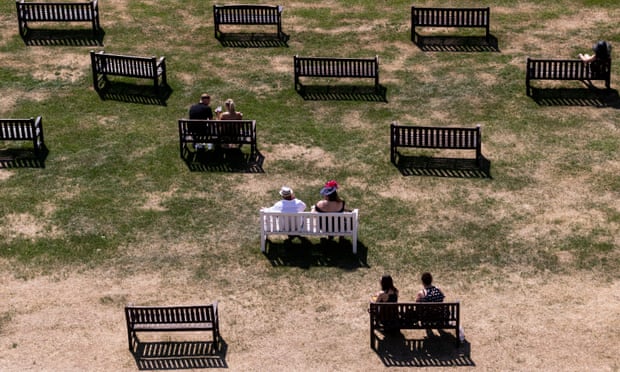 Top view of spectators sitting on benches in the dry grass