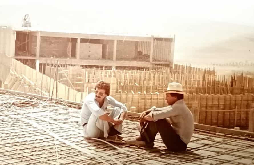 Anwar al-Bunni and another man, in 1982, sitting on part of the unfinished Saydnaya prison, which he helped build while working in construction before he began legal training.