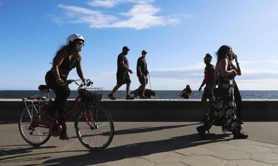 People exercise along the St Kilda beach promenade in Melbourne.