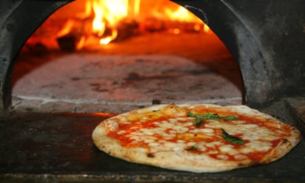 Neapolitan-style pizza in front of pizza oven