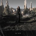 The artwork for The Dark, depicting Chelsea Wolfe in rocky landscape