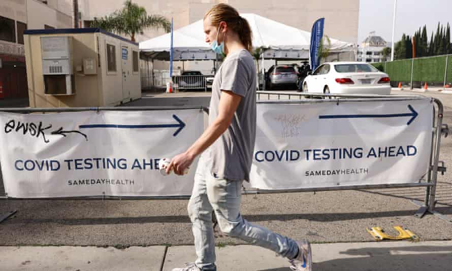 A man walks past a drive-through Covid-19 testing centre on 6 December in Los Angeles, California.