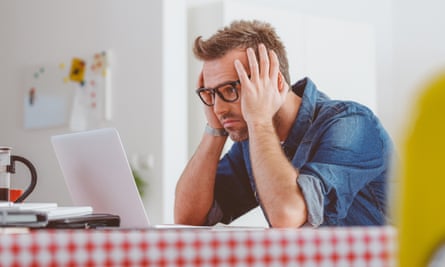 worried man looking at a laptop