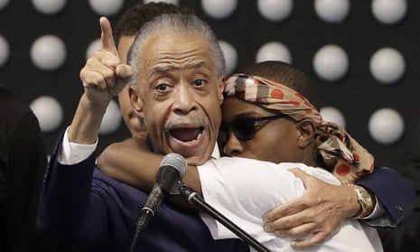 Al Sharpton, left, hugs Stephon’s brother Stevante Clark while speaking during the funeral service.