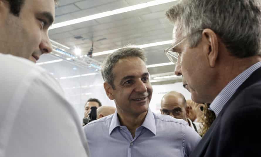 Greek Prime Minister Kyriakos Mitsotakis (C) and Minister of Digital Governance Kyriakos Pierrakakis (L) chat with US Ambassador to Greece Geoffrey Pyatt (R) in Thessaloniki, September 2019.