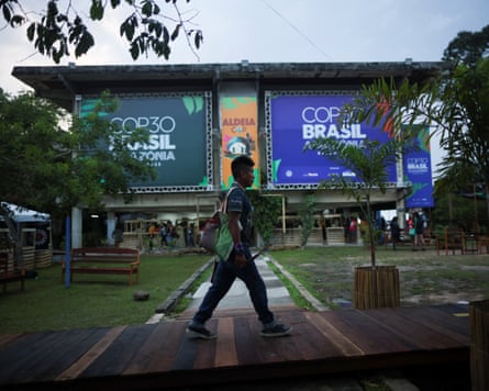 An Indigenous person walks in the Cop30 village in Belém.