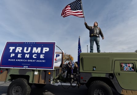 Veteran Dave Ragan waves a flag to attract supporters during the campaign rally in Wilkes-Barre, Pennsylvania, in 2020.