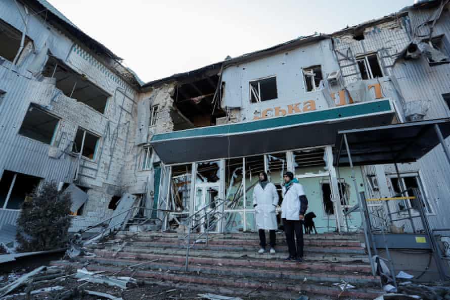Medical workers stand outside a local hospital, which was destroyed from shelling in the separatist-controlled town of Volnovakha in the Donetsk region, Ukraine.