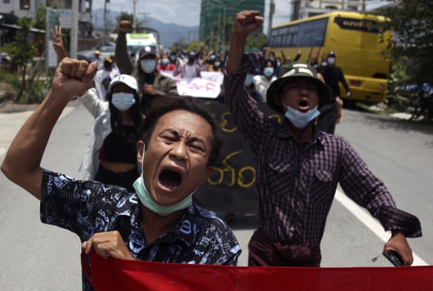 Myanmar demonstrators shout slogans as they march on a street during an anti-military coup protest in Mandalay, Myanmar, 13 May 2021. 