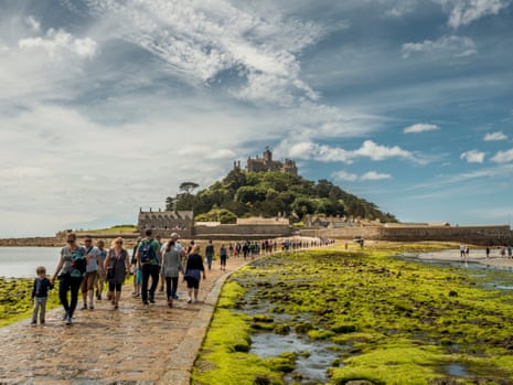 Visitors walk across the causeway to St Michael’s Mount.