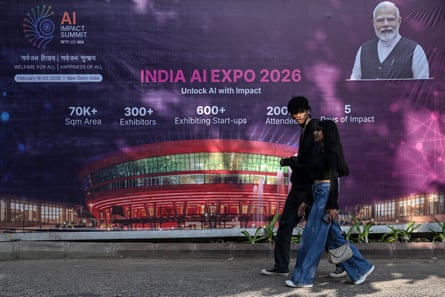Commuters pass a hoarding promoting the AI Impact Summit with Modi's photo in the corner