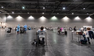 Passengers wait at a coronavirus testing centre in Hong Kong after arriving on a flight from overseas.