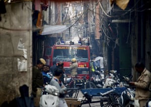 A fire engine stands by the site of a fire in a narrow lane in Delhi.