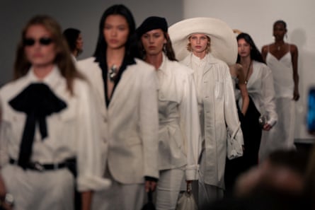 A line of female models dressed in white, loose summer outfits