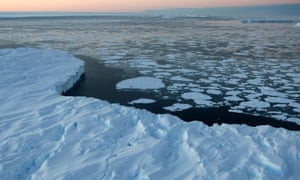 Giant tabular icebergs are surrounded by ice floe drift in Vincennes Bay, Antartica.