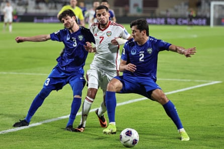 Uzbekistan’s Khojiakbar Alijonov and Abdukodir Khusanov vie for the ball against UAE’s Ali Saleh during a 2026 World Cup qualifier in June