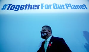 The Cop26 president, Alok Sharma, under a sign reading '#TogetherForOurPlanet'