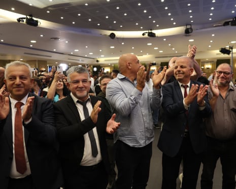 Head of the Joint List alliance Yousef Jabareen (second left) celebrates with supporters as the first exit polls are announced at campaign headquarters in Nazareth, Israel.