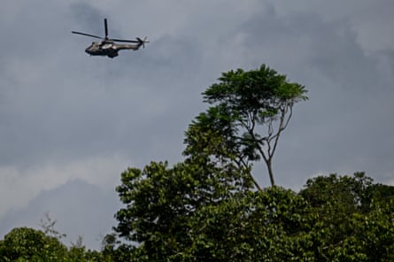 a helicopter flies over a forest