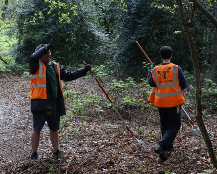 Gardeners rake twigs at Hadley Wood